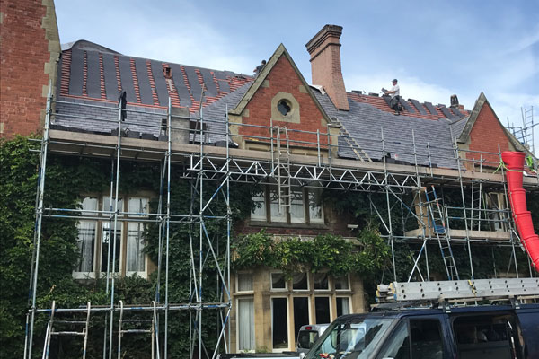 Roofing contractors working on terraced houses in North Wales