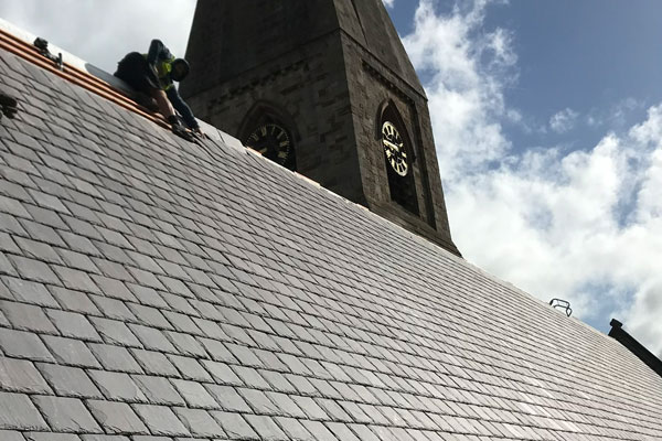 Roofing contractors working on church roof
