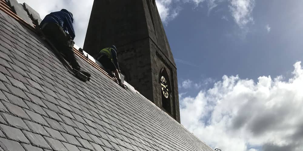 Roofing contractors working on church in North Wales